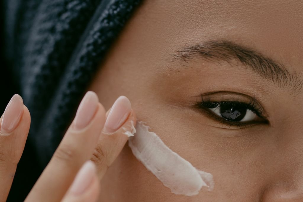 Applying a pea-sized amount of spot treatment to a pimple before bed