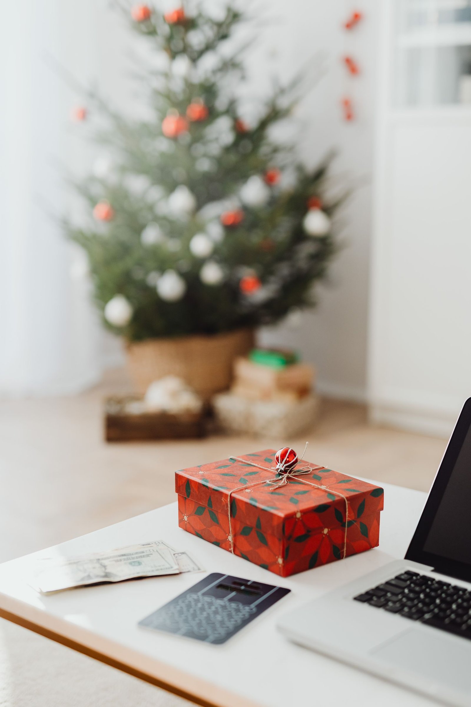 Christmas gifts for coworkers arranged on a festive office desk