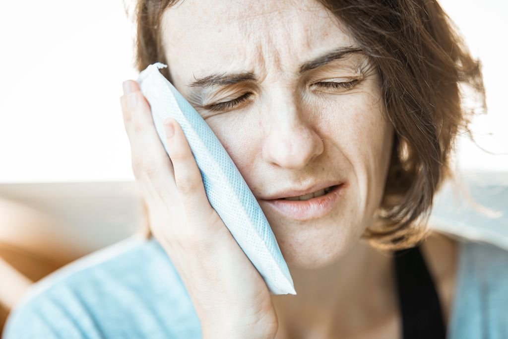 Cold compress calming swelling before an overnight acne treatment